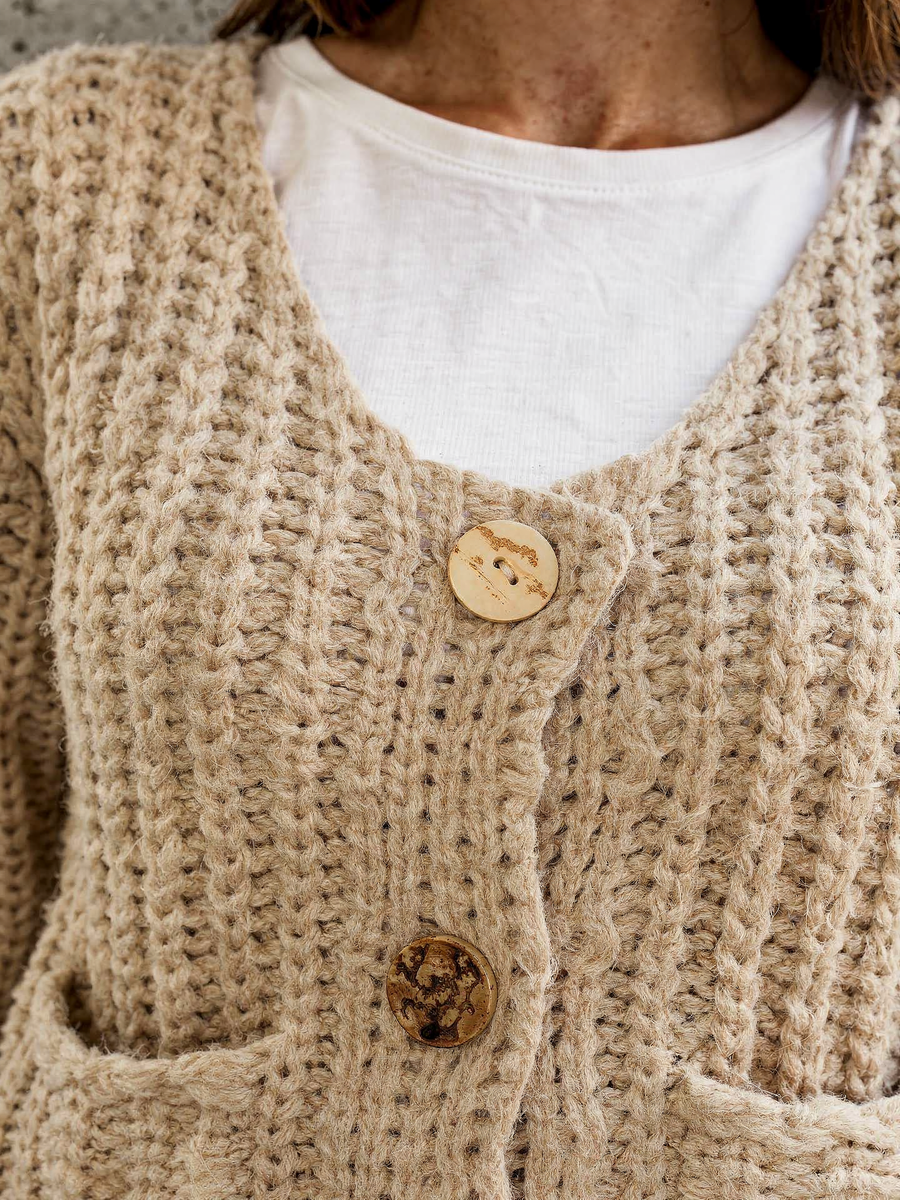 Close detail of the V-neckline and statement buttons